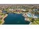 Overhead view features community center, swimming pool, surrounding lake and lush, landscaped grounds at 20627 N Lemon Drop Dr, Maricopa, AZ 85138