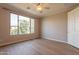 Bedroom featuring wood-look flooring, ceiling fan, and bright natural light at 20627 N Lemon Drop Dr, Maricopa, AZ 85138