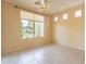 Serene bedroom with large window overlooking a landscaped backyard and tiled floor at 20627 N Lemon Drop Dr, Maricopa, AZ 85138