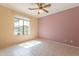 Bedroom with tile flooring, a ceiling fan, and a large window with natural light at 20627 N Lemon Drop Dr, Maricopa, AZ 85138