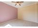 Spacious bedroom with tile flooring, ceiling fan, and neutral decor at 20627 N Lemon Drop Dr, Maricopa, AZ 85138