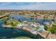 Aerial view of the community lake and pool showcasing palm trees, covered lounging, and beautiful landscape at 20627 N Lemon Drop Dr, Maricopa, AZ 85138