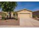 Charming single-story home with a desert landscape and a two-car garage at 20627 N Lemon Drop Dr, Maricopa, AZ 85138
