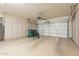 Spacious garage with storage cabinets and an automatic door, offering ample space for vehicles and storage at 20627 N Lemon Drop Dr, Maricopa, AZ 85138