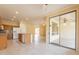 Open kitchen and dining area with sliding glass doors and granite countertops at 20627 N Lemon Drop Dr, Maricopa, AZ 85138