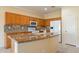 Bright kitchen features granite countertops, tiled backsplash, and modern appliances at 20627 N Lemon Drop Dr, Maricopa, AZ 85138