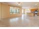 Spacious living room featuring large windows, neutral walls, and tile floors at 20627 N Lemon Drop Dr, Maricopa, AZ 85138