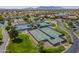 Aerial view of multiple tennis courts and lush landscaping at 20627 N Lemon Drop Dr, Maricopa, AZ 85138