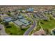Aerial view showcases the community's tennis courts, manicured lawns, a community center, and scenic ponds at 20627 N Lemon Drop Dr, Maricopa, AZ 85138