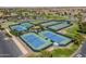 Aerial view of community tennis courts and lush green landscaping at 20627 N Lemon Drop Dr, Maricopa, AZ 85138