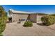 Home exterior showcasing a well-maintained gravel yard, shrubs, and mature trees at 215 N Power Rd # 340, Mesa, AZ 85205