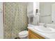 Well-lit bathroom with a printed shower curtain, toilet, and a white sink at 215 N Power Rd # 340, Mesa, AZ 85205