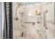 Modern shower with marble tile surround, stainless steel fixtures and ample storage at 215 N Power Rd # 340, Mesa, AZ 85205