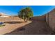 The backyard features a block wall for privacy and low-maintenance landscaping at 23805 W Romley Ave, Buckeye, AZ 85326