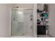 Clean bathroom with glass door shower and built-in shelving at 23805 W Romley Ave, Buckeye, AZ 85326