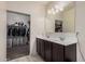 Bathroom featuring double sinks and a walk-in closet at 23805 W Romley Ave, Buckeye, AZ 85326