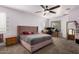 Carpeted bedroom featuring a large ceiling fan and windows at 23805 W Romley Ave, Buckeye, AZ 85326