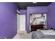 This bedroom features a purple accent wall and closet at 23805 W Romley Ave, Buckeye, AZ 85326