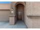 Inviting front entry featuring a charming archway and stylish exterior details at 23805 W Romley Ave, Buckeye, AZ 85326