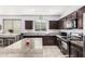 Updated kitchen featuring dark cabinets and granite countertops at 23805 W Romley Ave, Buckeye, AZ 85326