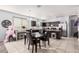 Bright kitchen and dining area featuring tile flooring, dark cabinets, and modern appliances at 23805 W Romley Ave, Buckeye, AZ 85326