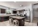 Modern kitchen with stainless steel appliances and granite island at 23805 W Romley Ave, Buckeye, AZ 85326