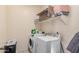 The laundry room features machines and storage at 23805 W Romley Ave, Buckeye, AZ 85326