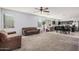 Spacious living room featuring plush carpeting, abundant natural light, and seamless flow to the dining area at 23805 W Romley Ave, Buckeye, AZ 85326