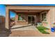 This covered patio features a sliding glass door, a concrete surface and a gravel surround at 23805 W Romley Ave, Buckeye, AZ 85326
