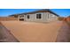 Backyard view of new construction home, showcasing a large, sand-filled area ready for customization at 24152 N 172Nd Ave, Surprise, AZ 85387