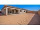 New construction home featuring a spacious, sand-filled backyard with a covered patio area at 24152 N 172Nd Ave, Surprise, AZ 85387