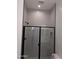 Clean and modern bathroom featuring a glass shower door, vertical tiles, black fixtures, and a tiled shower niche at 24152 N 172Nd Ave, Surprise, AZ 85387