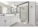 Bathroom featuring a double vanity with sleek fixtures and a glass shower with vertical tiles at 24152 N 172Nd Ave, Surprise, AZ 85387