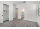 Cozy bedroom featuring carpet flooring, an open closet, and ensuite bathroom at 24152 N 172Nd Ave, Surprise, AZ 85387