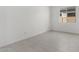 Bright bedroom with white walls, modern light tile floors, window, and ample natural light at 24152 N 172Nd Ave, Surprise, AZ 85387