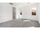 Bright bedroom featuring soft gray carpeting, white walls, ensuite bathroom and ample natural light at 24152 N 172Nd Ave, Surprise, AZ 85387