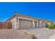 Charming home exterior with three-car garage, a stone facade, a desert landscape, and a paver driveway at 24152 N 172Nd Ave, Surprise, AZ 85387