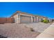 Charming home exterior with three-car garage, a stone facade, a desert landscape, and a paver driveway at 24152 N 172Nd Ave, Surprise, AZ 85387