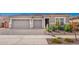 Charming home exterior with three-car garage, a stone facade, manicured lawn, and a lovely paver driveway at 24152 N 172Nd Ave, Surprise, AZ 85387