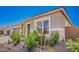 Charming single-story home with manicured landscaping, colorful plants, and paver driveway at 24152 N 172Nd Ave, Surprise, AZ 85387
