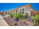 Charming single-story home with manicured landscaping, colorful plants, and paver driveway at 24152 N 172Nd Ave, Surprise, AZ 85387