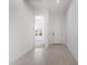 Clean and bright hallway with neutral paint, tiled floors and doors leading to other rooms at 24152 N 172Nd Ave, Surprise, AZ 85387