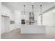 Bright kitchen with island, pendant lighting, stainless appliances, and white cabinetry at 24152 N 172Nd Ave, Surprise, AZ 85387