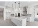 Bright kitchen with an island, pendant lighting, stainless appliances, and white cabinetry at 24152 N 172Nd Ave, Surprise, AZ 85387