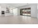 Bright open-concept living space with kitchen, large tile floors, and sliding glass doors to the backyard at 24152 N 172Nd Ave, Surprise, AZ 85387