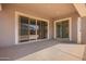 Covered patio with a sleek design, featuring sliding glass doors that open to the backyard at 24152 N 172Nd Ave, Surprise, AZ 85387
