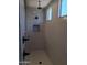Modern shower with vertical white tiles, matte black hardware, a recessed shelf, and a window providing natural light at 24152 N 172Nd Ave, Surprise, AZ 85387