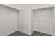 A walk-in closet with neutral walls, carpet flooring, and wooden shelving for storage at 24152 N 172Nd Ave, Surprise, AZ 85387