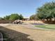 Backyard with pool, rock waterfall, trampoline, and putting green at 24228 S 211Th St, Queen Creek, AZ 85142
