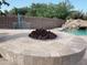 Backyard with built in gas fire pit next to the pool and rock waterfall at 24228 S 211Th St, Queen Creek, AZ 85142